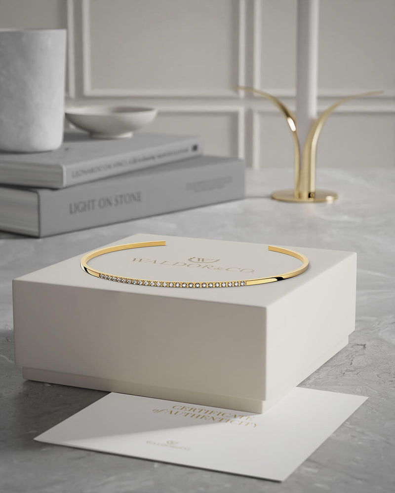 A Bangle in 14k gold-plated 316L stainless steel from Waldor & Co. One size. The model is Bliss Bangle Polished.