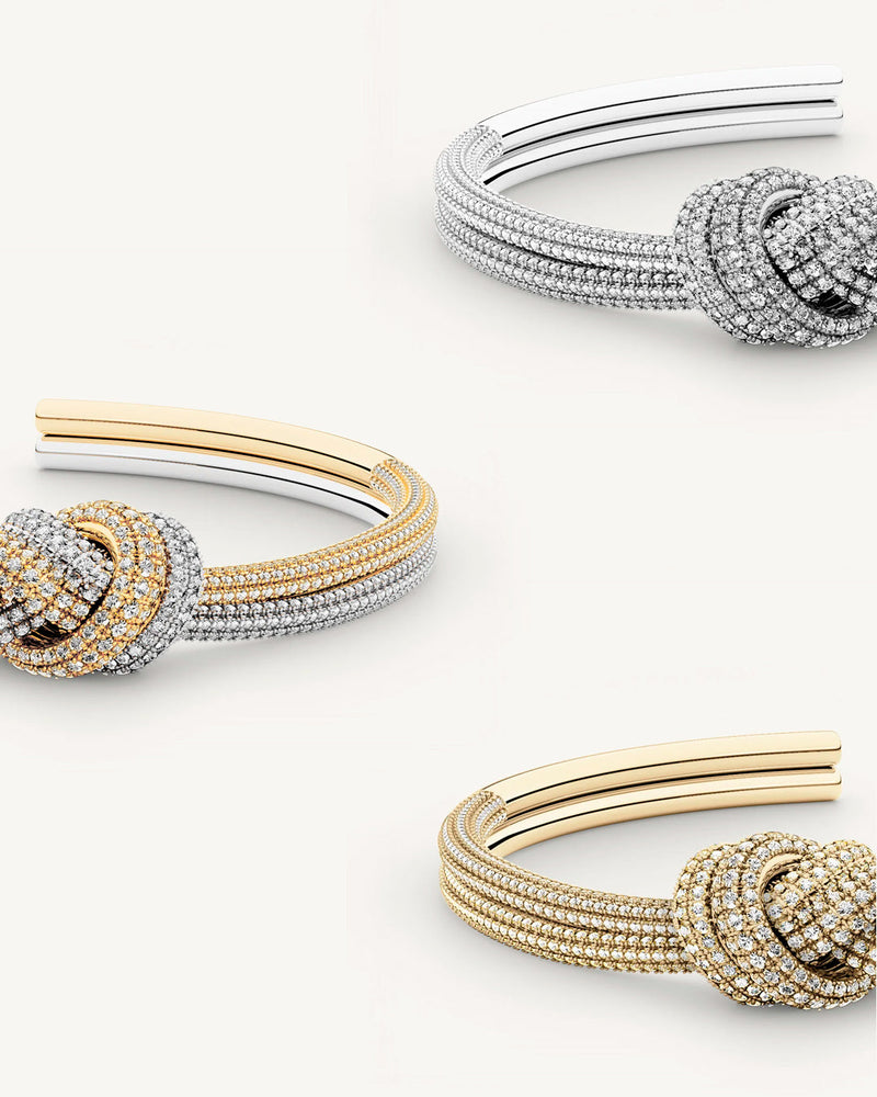 Three bangles in 14k-gold and silver plated copper from Waldor & Co. One size. The model is Dual Knot Bangle Pavè.