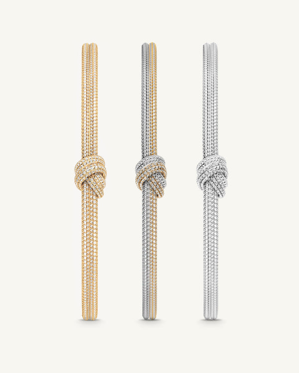 Three bangles in 14k-gold and silver plated copper from Waldor & Co. One size. The model is Dual Knot Bangle Pavè.