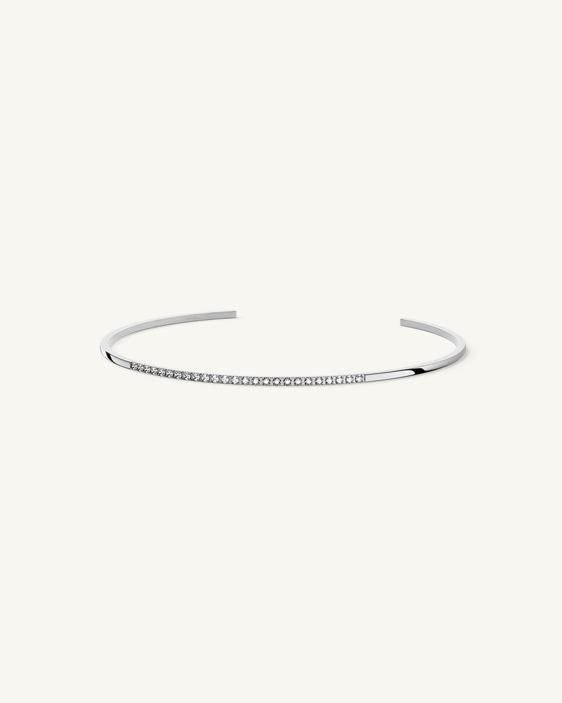 A Bangle in Rhodium-plated 316L stainless steel from Waldor & Co. One size. The model is Bliss Bangle Polished.