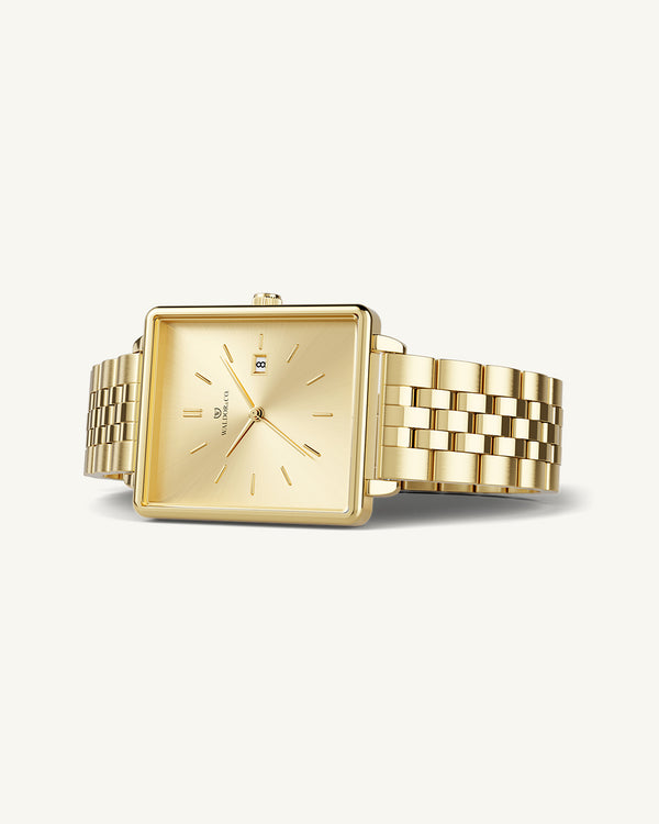 A square womens watch in 14k gold from Waldor & Co. with gold sunray dial and a second hand. Seiko movement. The model is Delight 32 Chelsea 28x32mm.