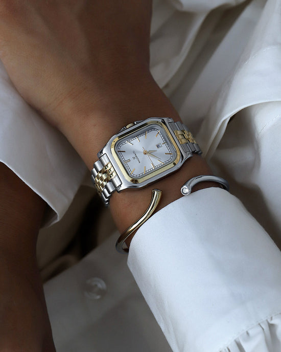 lifestyle_image, A square womens watch in silver and 14k gold from Waldor & Co. with silver sunray dial and a second hand. Seiko movement. The model is Delight 32 Chelsea 28x32mm.