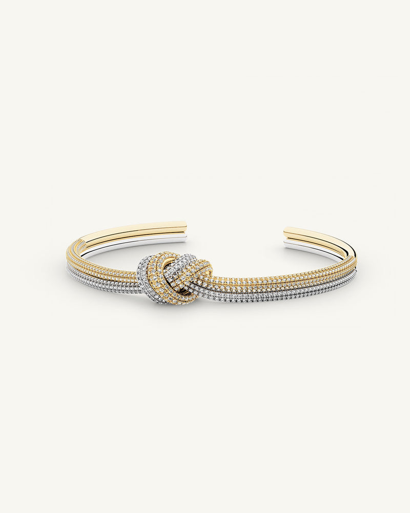 A Bangle in 14k-gold plated and silver polished copper from Waldor & Co. One size. The model is Dual Knot Bangle Pavè.