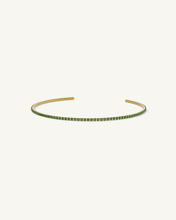 A Bangle in 14k gold-plated 316L stainless steel with green stones from Waldor & Co. One size. The model is Dulcet Bangle Polished.
