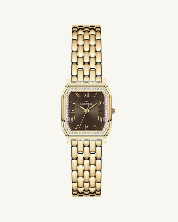A square womens watch in Rhodium-plated 316L stainless steel from Waldor & Co. with a deep brown dial. Bezel with premium crystals. Diamond Cut Sapphire Crystal glass dial. Seiko movement. The model is Eternal 22 Bellagio Pavè.