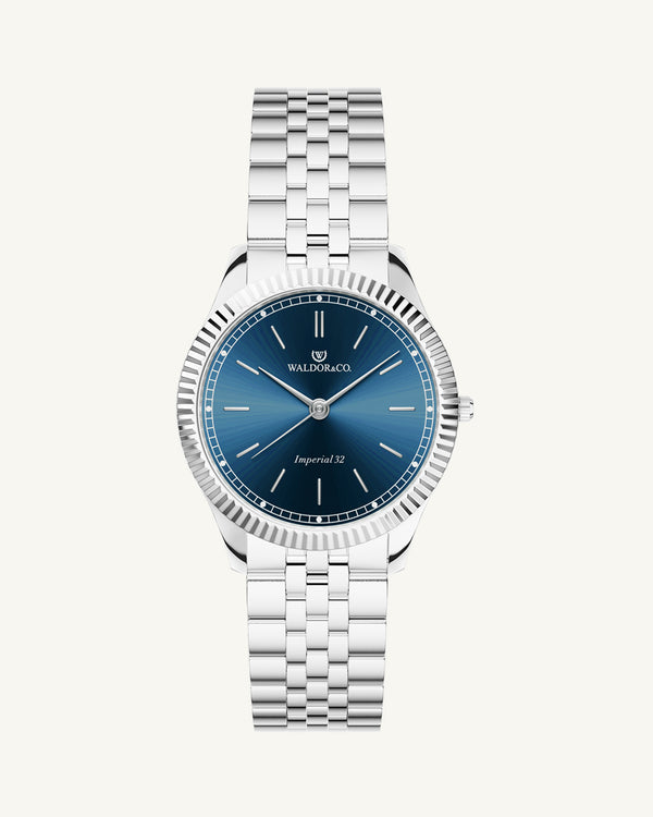 A round womens watch in silver from Waldor & Co. with blue sunray dial and a second hand. Seiko movement. The model is Imperial 32 Positano 32mm.