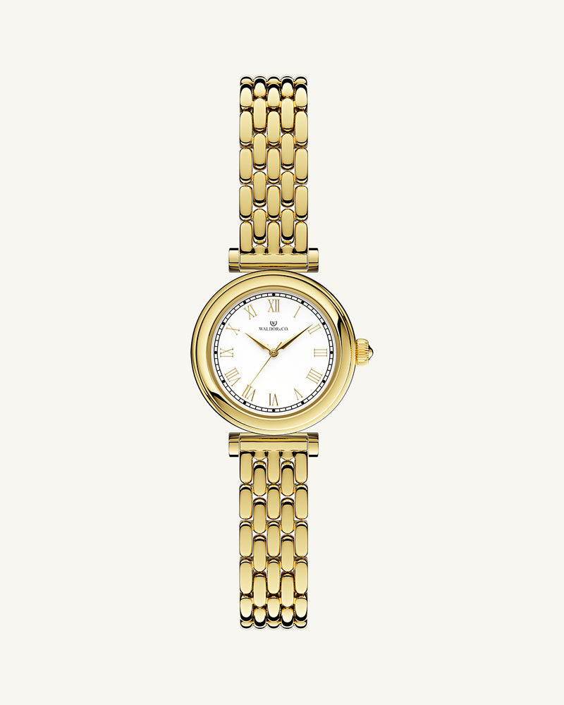 A round womens watch in 22k gold plated 316L stainless steel from Waldor & Co. with white Sapphire Crystal glass dial. Seiko movement. The model is Venia 24 Villefranche.